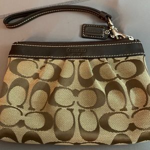Coach brown small wristlet, brown and tan. Used but in great condition!
